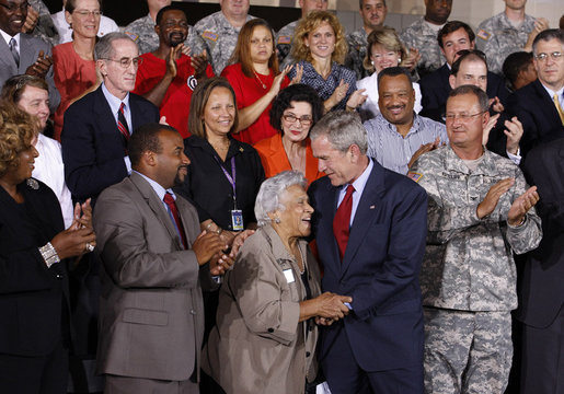 President George W. Bush embraces New Orleans chef and restaurant owner Leah Chase following his address Wednesday, Aug. 20, 2008 at the historic Jackson Barracks in New Orleans, where President Bush honored residents and community leaders for their determination to rebuild their communities three years after Hurricane Katrina devastated the Gulf Coast region. White House photo by Eric Draper