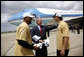 President George W. Bush is welcomed by New Orleans Saints running back Deuce McAllister, left, and Saints quarterback Drew Brees upon his arrival Wednesday, Aug. 20, 2008 to the Louis Armstrong International Airport in New Orleans. White House photo by Eric Draper