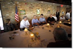 President George W. Bush is joined by Mississippi Governor Haley Barbour, second fromleft, and Gulfport, Miss., Mayor Brent Warr, right, Wednesday, Aug. 20, 2008 during a dinner with community leaders in Gulfport. Miss., to discuss the continued recovery efforts three years after Hurricane Katrina. White House photo by Eric Draper