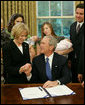 President George W. Bush holds the hand of Peggy Hubbard, mother of the Hubbard brothers, after signing H.R. 6580, The Hubbard Act, Aug. 29, 2008, in the Oval Office of the White House. The Hubbard Act is named in honor of brothers Jared and Nathan Hubbard , who lost their lives serving our country in Iraq. Their brother, Jason Hubbard was discharged from the Army as a sole survivor but was denied separation benefits. H.R. 6580 will provide sole survivors a number of benefits already offered to other soldiers honorably discharged from military service. White House photo by Chris Greenberg