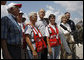 President George W. Bush stands with a group of Red Cross volunteers as he talks with reporters Monday, Sept. 1, 2008 at the Alamo Regional Command Reception Center at Lackland Air Force Base in San Antonio, Texas, where the President participated in a briefing on the response preparation for Hurricane Gustav. Texas Senator Kay Bailey Hutchison and FEMA Administrator David Paulison are seen at right. White House photo by Eric Draper