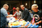 Mrs. Laura Bush, joined by Mrs. Cindy McCain, right, help HIV and AIDS advocate Princess Kasune Zulu, left, and One Chairman and CEO David Lane assemble care-giver packages at the ONE campaign event Tuesday, Sept. 2, 2008 at the Minneapolis Convention Center in Minneapolis, in support of health care workers who treat AIDS paitients in African countries. White House photo by Shealah Craighead