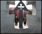 Seen through the Holodomor Memorial, Vice President Dick Cheney observes a moment of silence Friday, Sept. 5, 2008 in Kyiv, to remember the millions of Ukrainians murdered between 1932-33 during a Soviet enforced artificial famine. Mrs. Kateryna Yushchenko, wife of Ukrainian President Yushchenko, is at right. White House photo by David Bohrer