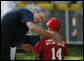 President George W. Bush presents a game ball to Stripes player Adam Plante, 6, of Burke, Va., following the Tee Ball on the South Lawn: A Salute to the Troops game Sunday, Sept. 7, 2008, played by the children of active-duty military personnel. White House photo by Andrew Hreha