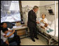 President George W. Bush visits with U.S. Army Sgt. Pengchun Pech of Lynne, Mass., Tuesday, Sept. 9, 2008, at Walter Reed Army Medical Center, where the soldier is recovering from wounds received during Operation Iraqi Freedom. Looking on is his wife, Leakhenavodey Pech, and 22-month-old son, Tommy, sit nearby. White House photo by Eric Draper