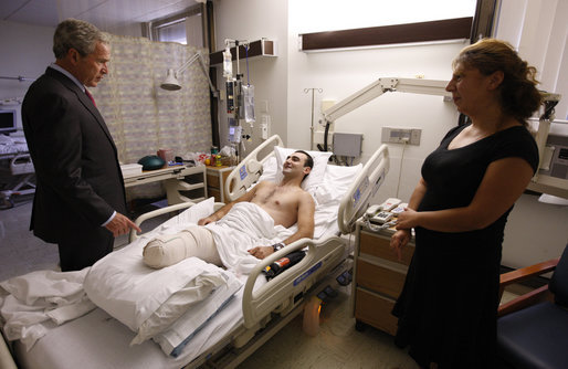 President George W. Bush speaks with Sgt. Besiki Balakhadze, a member of the Georgian Army Coalition Forces, during a visit Tuesday, Sept. 9, 2008, to Walter Reed Army Medical Center in Washington, D.C., where the soldier is recovering from wounds received during Operation Iraqi Freedom. With them is interpreter Staff Sgt. Tatiana Ivanova, also of the Georgian Army Coalition Forces. White House photo by Eric Draper