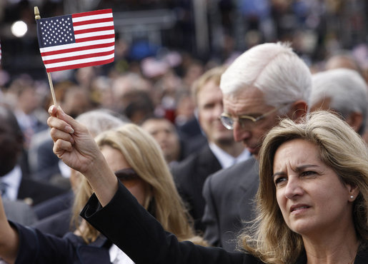 A woman waves an American flag during the dedication ceremony of the 9/11 Pentagon Memorial Thursday, Sept. 11, 2008, in Arlington, Va. White House photo by Eric Draper