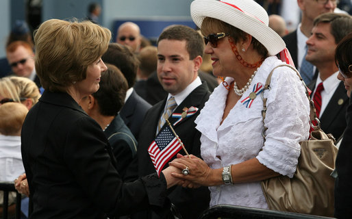 Mrs. Laura Bush speaks with a family member attending the Pentagon Memorial dedication ceremony Thursday, Sept. 11, 2008 at the Pentagon in Arlington, Va., where 184 memorial benches were unveiled honoring all innocent life lost when American Airlines Flight 77 crashed into the Pentagon on Sept. 11, 2001. White House photo by Joyce N. Boghosian