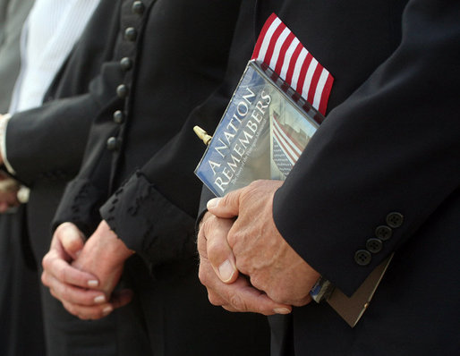 Vice President Dick Cheney is seen holding a flag and a commemorative program during the dedication ceremony of the 9/11 Pentagon Memorial Thursday, Sept. 11, 2008, at the Pentagon in Arlington, Va. White House photo by David Bohrer