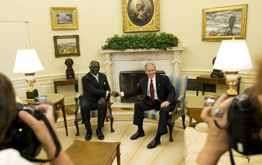 President George W. Bush and President John Agyekum Kufuor of Ghana pause for photos in the Oval Office prior to their meeting Monday, Sept. 15, 2008, at the White House. White House photo by Eric Draper