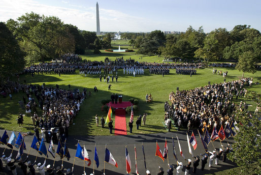 President George W. Bush and President John Agyekum Kufuor of Ghana, seen from the Truman Balcony of the White House, stand together during the South Lawn Arrival Ceremony of President John Agyekum Kufuor and Mrs. Theresa Kufuor of Ghana at the White House. White House photo by Grant Miller