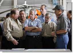 President George W. Bush meets with locals officials at the U.S. Coast Guard facility at Ellington Field in Houston Tuesday, Sept. 16, 2008 before taking an aerial tour of Texas areas damaged in last weekend's hurricane. Said the President afterward, "My first observation is that the state government and local folks are working very closely and working hard and have put a good response together. The evacuation plan was excellent in its planning and in execution. The rescue plan was very bold, and we owe a debt of gratitude to those who were on the front line pulling people out of harm's way, like the Coast Guard people behind us here."  White House photo by Eric Draper