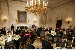 President George W. Bush welcomes guests to the Iftaar Dinner with Ambassadors and Muslim leaders in the State Dining Room of the White House, Thursday, Sept. 17, 2008, to celebrate the traditions of Islamic faith and culture. White House photo by Chris Greenberg