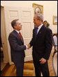 President George W. Bush welcomes Colombian President Alvaro Uribe into the Oval Office Saturday, Sept. 20, 2008, at the White House. White House photo by Eric Draper