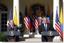 President George W. Bush listens as Colombian President Alvaro Uribe speaks to a reporter Saturday, Sept. 20, 2008, during a joint press availability in the Rose Garden at the White House. White House photo by Eric Draper