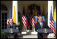 President George W. Bush listens as Colombian President Alvaro Uribe speaks to a reporter Saturday, Sept. 20, 2008, during a joint press availability in the Rose Garden at the White House. White House photo by Eric Draper