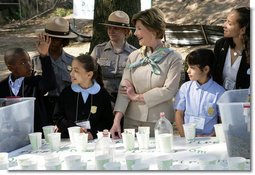 Mrs. Laura Bush and children from the Adam Clayton Powell Jr. Elementary School (P.S. 153) and the Boys and Girls Club of Harlem do 'cup planting' as part of the First Bloom program at the Hamilton Grange National Memorial in New York City, Sept. 24, 2008. The children will take care of the seedlings in the cups throughout the winter and plant them in the park in the spring. White House photo by Chris Greenberg