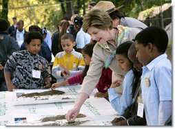 Mrs. Laura Bush and children from the Adam Clayton Powell Jr. Elementary School (P.S. 153) and the Boys and Girls Club of Harlem do a 'soil sampling' as part of the First Bloom program at the Hamilton Grange National Memorial in New York City, Sept. 24, 2008. The activity helps children learn about the characteristics of local soil and thus the kinds of plants best suited to the area. The park is the historic home of Alexander Hamilton. White House photo by Chris Greenberg