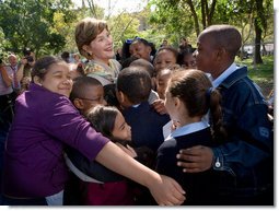 Mrs. Laura Bush receives a big group hug from children visiting from the Adam Clayton Powell Jr. Elementary School (P.S. 153) and the Boys and Girls Club of Harlem at the conclusion of a First Bloom program at the Hamilton Grange National Memorial in New York City, Sept. 24, 2008. The First Bloom program is a national conservation education program for the National Park Foundation that encourages young people to protect the environment in America's National Parks and in their own back yards. White House photo by Chris Greenberg