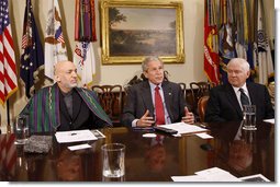 President George W. Bush is joined by President Hamid Karzai of Afghanistan during a video teleconference with U.S. Provincial Reconstruction team leaders, National Guard Agriculture Development team representatives and Afghan governors Friday, Sept. 26, 2008, in the Roosevelt Room at the White House. U.S. Secretary of Defense Robert Gates is seen at right.  White House photo by Eric Draper