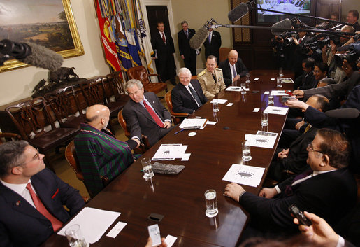 President George W. Bush thanks President Hamid Karzai of Afghanistan for his participation in a video teleconference with U.S. Provincial Reconstruction team leaders, National Guard Agriculture Development team representatives and Afghan governors Friday, Sept. 26, 2008, in the Roosevelt Room at the White House. U.S. Secretary of Defense Robert Gates, Chairman of the Joints Chief of Staff Admiral Michael Mullen and Deputy Secretary of State John Negroponte are seen at right. White House photo by Eric Draper