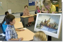 Mrs. Laura Bush watches during a visit to the fourth-grade classroom of Susan Weekes at the Riverside Elementary School in Bismarck, N.D., Thursday, Oct. 2, 2008, as Ms. Weekes shows students a painting by Emanuel Leutze of General George Washington crossing the Delaware River. The First Lady was visiting the school to highlight the National Endowment for the Humanities ' Picturing America' program which provides iconic artwork and photography for students to study. White House photo by Chris Greenberg