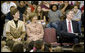 Mrs. Laura Bush enjoys a school assembly program, with Ms. Wilda Lu Nelson, Principal of the Riverside Elementary School, left, and Dr. Thomas Lindsay, Deputy Chairman of the National Endowment for the Humanities, during a visit to the school in Bismarck, N.D., Thursday, Oct. 2, 2008. White House photo by Chris Greenberg