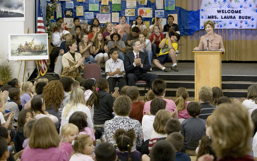 Mrs. Laura Bush addresses the Riverside Elementary School assembly in Bismarck, N.D., Thursday, Oct. 2, 2008, about the National Endowment for the Humanities' Picturing America' program. The program uses iconic artwork - such as the Washington Crossing the Delaware painting displayed nearby - and photography to teach children about architecture, art, and history as they discuss the images. White House photo by Chris Greenberg