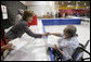 Mrs. Laura Bush hands a meal to Hurricane Ike evacuee Barbara Woodarek Friday, Oct. 3, 2008, during her visit to the Auchan Red Cross Shelter in Houston for those individiuals and families still in need of assistance as a result of Hurricane Ike. White House photo by Chris Greenberg