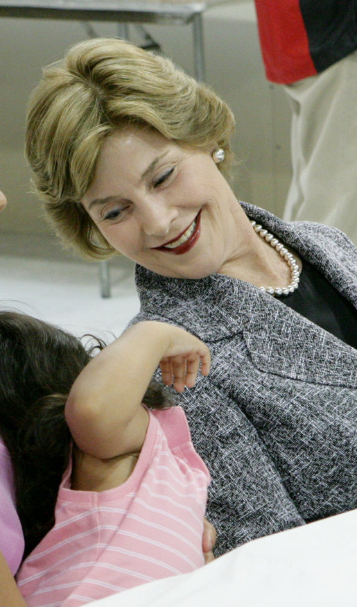 Mrs. Laura Bush shares a moment with Delilah Winters, 3, during a visit Friday, Oct. 3, 2008, to the Auchan Red Cross Shelter in Houston for those individiuals and families who still need assistance as a result of Hurricane Ike. White House photo by Chris Greenberg