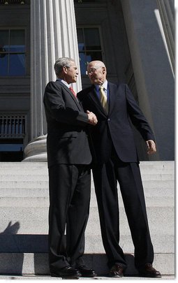 President George W. Bush shakes hands with Secretary Hank Paulson of the U.S. Department of Treasury after visiting the department Friday, Oct. 3, 2008. Said the President upon his departure, "Mr. Secretary, you and your team have worked incredibly hard. You've worked with the Congress; you've worked with the financial markets, both domestically and internationally. I know that your people are exhausted in there, and I really appreciate the fact that I'll be signing a piece of legislation that will be a part of solving this crisis, an important part of solving the crisis." White House photo by Eric Draper