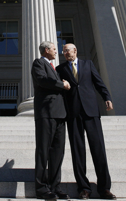 President George W. Bush shakes hands with Secretary Hank Paulson of the U.S. Department of Treasury after visiting the department Friday, Oct. 3, 2008. Said the President upon his departure, "Mr. Secretary, you and your team have worked incredibly hard. You've worked with the Congress; you've worked with the financial markets, both domestically and internationally. I know that your people are exhausted in there, and I really appreciate the fact that I'll be signing a piece of legislation that will be a part of solving this crisis, an important part of solving the crisis." White House photo by Eric Draper