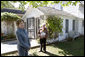 Mrs. Laura Bush talks with press outside the Mansfield, Mo., home of author Laura Ingalls Wilder after Mrs. Jean Coday, Director and President of the Laura Ingalls Wilder Historic Home and Museum, offered the First Lady a tour of the modest home. The home was designated this week as a Save America's Treasures project, which is in partnership with the National Trust for Historic Preservation. Mrs. Bush noted that Wilder, who wrote the "Little House" book series, was one of her favorite authors. "My mother read them to me when I was little before I could read," she said. White House photo by Chris Greenberg