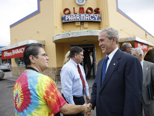 President George W. Bush shakes hands with Betty Garza, owner of Olmos Pharmacy, during his visit to establishment Monday, Oct. 6, 2008, in San Antonio, Texas. The Pharmacy -- no longer a pharmacy -- is known for its hamburgers and milkshakes and prior to becoming its owner, Ms. Garza served as its counter waitress for more than 35 years. White House photo by Eric Draper