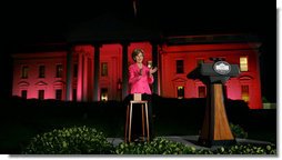 Mrs. Laura Bush applauds after pushing the button to flood the north front of the White House with a sea of pink, in honor of Breast Cancer Awareness Month, on Oct. 7, 2008. Bush addressed breast cancer survivors and advocates and members of the diplomatic corps just before the light display. The First Lady has encouraged worldwide efforts in preventing and curing a disease that is the leading cause of death in women. Each year more than 1.2 million people worldwide are diagnosed with breast cancer. The United States is working with countries in the Middle East, Europe and the Americas to empower women to take control of their health, raise awareness about the importance of prevention and early diagnosis, and support collaborative research to find a breast cancer cure.  White House photo by Chris Greenberg