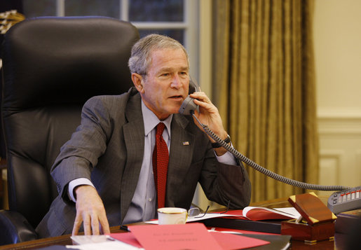 President George W. Bush speaks on the phone in the Oval Office Tuesday, Oct. 7, 2008, with Prime Minister Gordon Brown of the United Kingdom, discussing efforts to solve the spreading global financial crisis. President Bush also held phone conversations with French President Nicolas Sarkozy and Italian Prime Minister Silvio Berlusconi. White House photo by Eric Draper