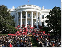 President George W. Bush joined by Mrs. Laura Bush receives applause during his remarks to the members of the 2008 United States Summer Olympic and Paralympic Teams Tuesday, Oct. 7, 2008, on the South Lawn of the White House. President Bush said, "You amazed the world with your talent and grace and sportsmanship. You inspired children to chase their dreams. You will be champions forever."  White House photo by Joyce N. Boghosian