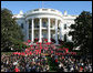 President George W. Bush joined by Mrs. Laura Bush receives applause during his remarks to the members of the 2008 United States Summer Olympic and Paralympic Teams Tuesday, Oct. 7, 2008, on the South Lawn of the White House. President Bush said, "You amazed the world with your talent and grace and sportsmanship. You inspired children to chase their dreams. You will be champions forever." White House photo by Joyce N. Boghosian