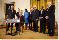 President George W. Bush signs H.R. 7081, The United States-India Nuclear Cooperation Approval and Nonproliferation Enhancement Act, Wednesday, Oct. 8, 2008, in the East Room at the White House. President Bush is joined on stage by, from left, Rep. Joseph Crowley, D-N.Y., Rep. Eliot Engel, D-N.Y., Secretary of State Condoleezza Rice, Sen. Chris Dodd, D-Conn., Senator John Warner of Virginia, Energy Secretary Samuel Bodman, India's Ambassador to the United States Ronen Sen and Vice President Dick Cheney. White House photo by Eric Draper