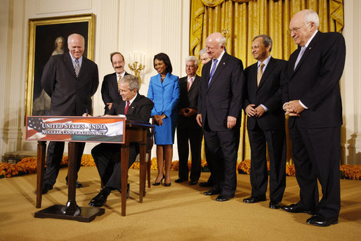 President George W. Bush signs H.R. 7081, The United States-India Nuclear Cooperation Approval and Nonproliferation Enhancement Act, Wednesday, Oct. 8, 2008, in the East Room at the White House. President Bush is joined on stage by, from left, Rep. Joseph Crowley, D-N.Y., Rep. Eliot Engel, D-N.Y., Secretary of State Condoleezza Rice, Sen. Chris Dodd, D-Conn., Senator John Warner of Virginia, Energy Secretary Samuel Bodman, India's Ambassador to the United States Ronen Sen and Vice President Dick Cheney. White House photo by Eric Draper