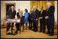 President George W. Bush signs H.R. 7081, The United States-India Nuclear Cooperation Approval and Nonproliferation Enhancement Act, Wednesday, Oct. 8, 2008, in the East Room at the White House. President Bush is joined on stage by, from left, Rep. Joseph Crowley, D-N.Y., Rep. Eliot Engel, D-N.Y., Secretary of State Condoleezza Rice, Sen. Chris Dodd, D-Conn., Senator John Warner of Virginia, Energy Secretary Samuel Bodman, India's Ambassador to the United States Ronen Sen and Vice President Dick Cheney. White House photo by Eric Draper