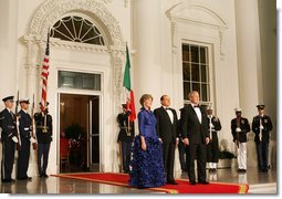 President George W. Bush and Mrs. Laura Bush welcome Italian Prime Minister Silvio Berlusconi Monday evening, Oct. 13, 2008, to the North Portico of the White House for a State Dinner in his honor. White House photo by Eric Draper