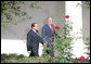 President George W. Bush and Italian Prime Minister Silvio Berlusconi walk together Monday, Oct. 13, 2008 along the West Wing Colonnade, following their joint press availability in the White House Rose Garden. White House photo by Chris Greenberg