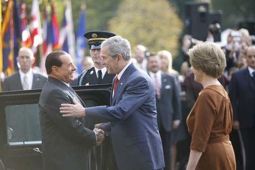 President George W. Bush and Mrs. Laura Bush welcome Italian Prime Minister Silvio Berlusconi upon his arrival Monday, Oct. 13, 2008 to the White House. White House photo by Eric Draper