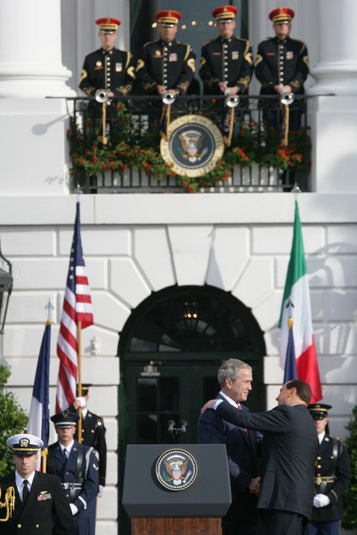 President George W. Bush is embrace by Prime Minister Silvio Berlusconi folllowing President Bush's remarks Monday, Oct. 13, 2008 , welcoming Prime Minister Berlusconi to the White House. White House photo by Chris Greenberg