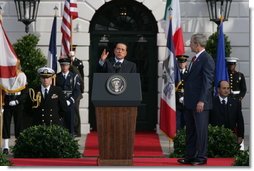 President George W. Bush listens as Prime Minister Silvio Berlusconi addresses his remarks Monday, Oct. 13, 2008, during ceremonies on the South Lawn to welcome Prime Minister Berlusconi to the White House. White House photo by Chris Greenberg