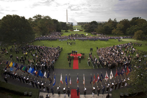 President George W. Bush and Prime Minister Silvio Berlusconi of Italy, seen from the Truman Balcony of the White House, stand together during the playing of the National Anthems at the South Lawn Arrival Ceremony of Prime Minister Silvio Berlusconi of Italy Monday, Oct. 13, 2008, at the White House. White House photo by Grant Miller