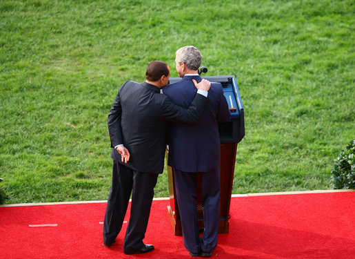 President George W. Bush is embraced by Prime Minister Silvio Berlusconi as he honors the Italian leader Monday, Oct. 13, 2008, during an official welcoming ceremony on the South Lawn of the White House. White House photo by Grant Miller