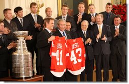 President George W. Bush stands with Detroit Red Wings captain Nicklas Lidstrom as they hold up jerseys Tuesday, Oct. 14, 2008 in the East Room at the White House, representing President Bush's father 41 and the President 43, during the ceremony to honor the Red Wings 2008 Stanley Cup championship. White House photo by Chris Greenberg