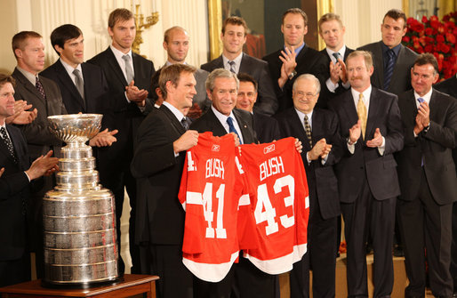 President George W. Bush stands with Detroit Red Wings captain Nicklas Lidstrom as they hold up jerseys Tuesday, Oct. 14, 2008 in the East Room at the White House, representing President Bush's father 41 and the President 43, during the ceremony to honor the Red Wings 2008 Stanley Cup championship. White House photo by Chris Greenberg